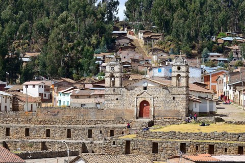 Inca sun temple with colonial cathedral on top in the middle of the village