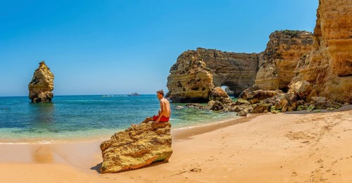 Young man sitting on a rock