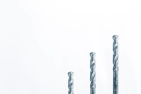 Three drills in front of white surface