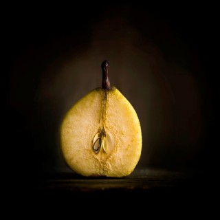 Halved pear on dark background