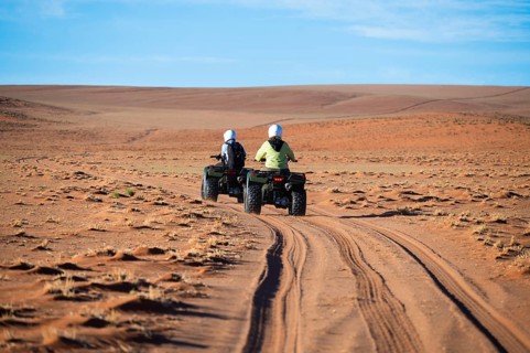 Quadbiker on sand track in the Namib