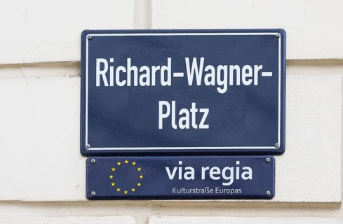 Street sign Richard-Wagner-Platz and sign for the Via Regia European Cultural Route on a house wall