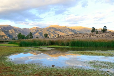 Reflection of bare hills in the Laguna Pumaqucha at the Inca ruins of Inti Watana