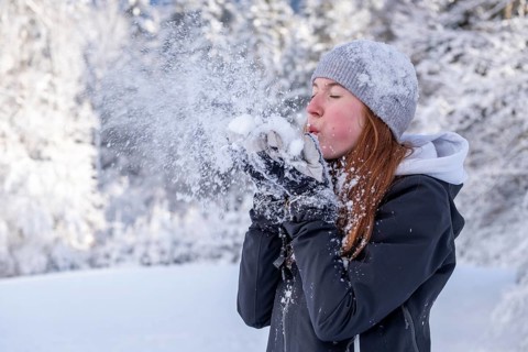 Woman enjoying the snow during winter walk