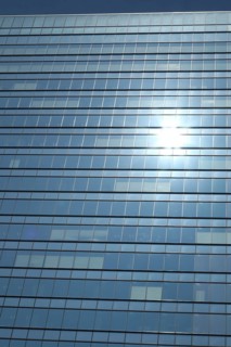 Glas facade of a business building with reflecting sun in Ginza district