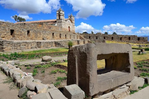 Sacrificial stone in front of the Inca Sun Temple with attached cathedral from the colonial period