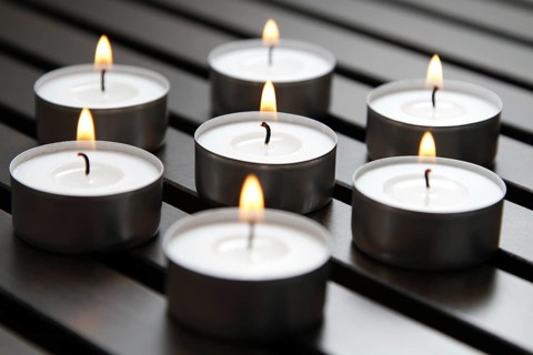 Tea lights on wooden background