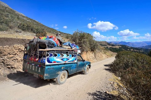 Heavily loaded pickup truck on gravel road