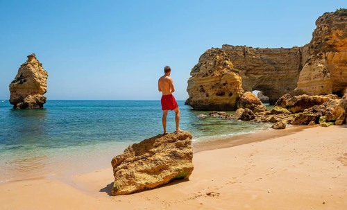 Young man standing on a rock