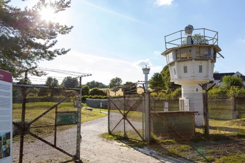 Outdoor area of the German-German Museum Moedlareuth with observation tower and historical barrier installations