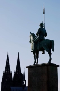 Monument of the 8th Prussian Cuirassier Regiment with the silhouette of the cathedral