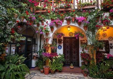 Entrance door and archway in courtyard decorated with flowers