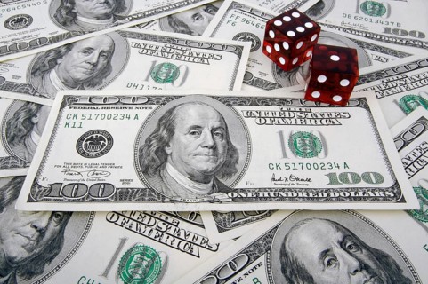 One hundred dollar bills with two red dice