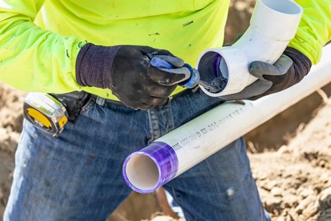 Plumber applying pipe cleaner