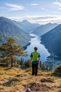 Hiker looks at Plansee