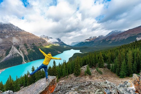 Hiker stretches his arms in the air