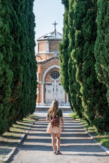 Young woman on the main path of the cemetery island San Michele