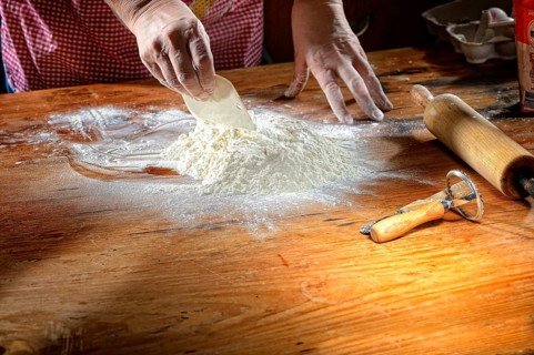 Flour with eggs on wooden table