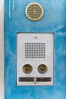 Bell sign on a blue house wall