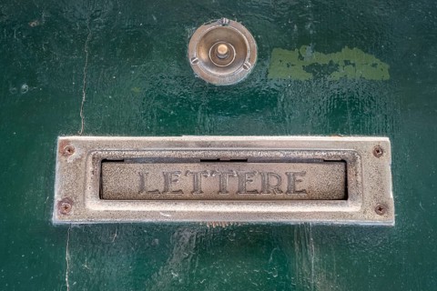 Bell and letter slot with inscription Lettere on house wall