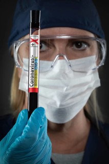 Female Lab Worker Holds Test Tube of Blood Labeled Coronavirus COVID-19 Disease