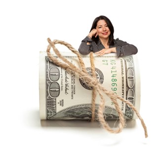 Attractive hispanic woman leaning on a roll of one hundred dollar bills isolated on a white background