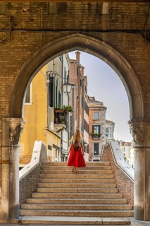 Young woman with red skirt on stairs
