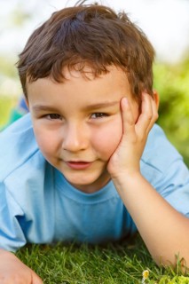 Child little boy portrait thinking looking meadow outside
