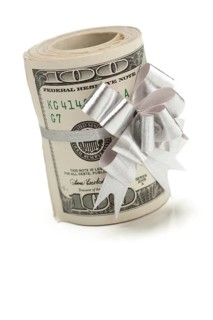 Roll of one hundred dollar bills tied in a silver bow on a white background