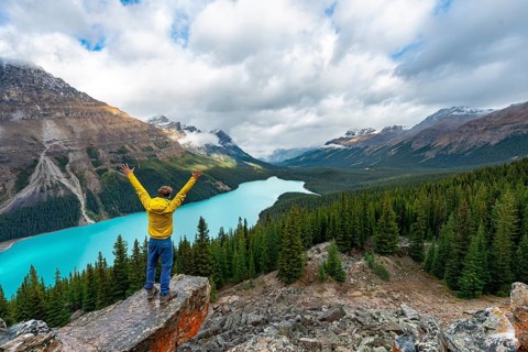 Hiker stretches his arms in the air