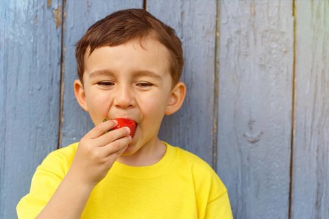 Child little boy eating strawberry summer strawberries
