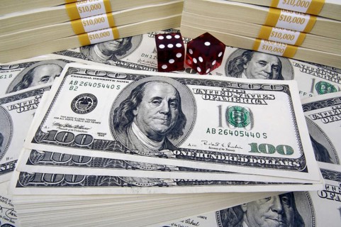 One hundred dollar bills with two red dice