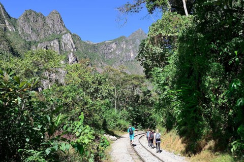 Hikers on the railway tracks in the Urubamba Valley towards Cusco