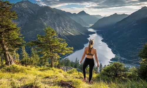 Hiker in sport clothes looking at Plansee