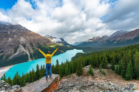Hiker stretches his arms in the air
