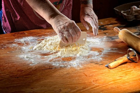 Woman mixes fresh pasta dough