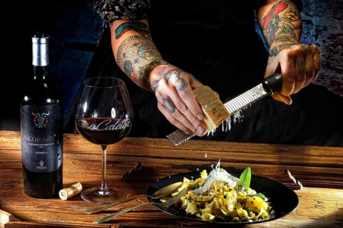 Woman with tattooed hands and fresh pasta