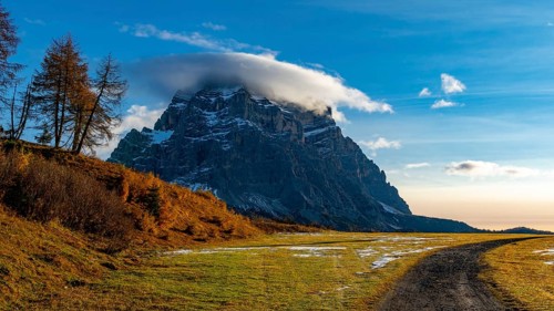 Peak of Monte Pelmo in the morning light with autumn landscape