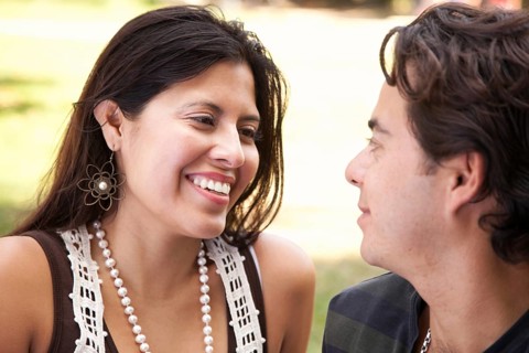 Happy attractive hispanic couple enjoying themselves at the park
