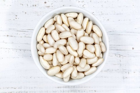 White beans raw from above wooden board