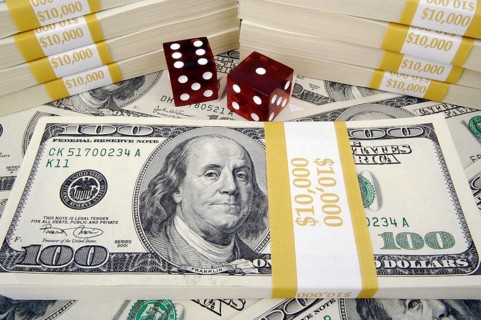 One hundred dollar bills with two red dice