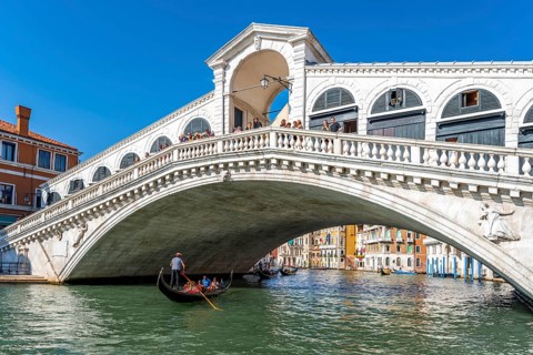 Gondola with tourists on the Grand Canal
