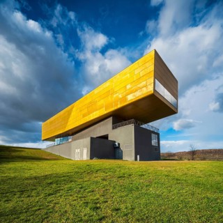 Nebra Ark on green meadow with cloudy sky