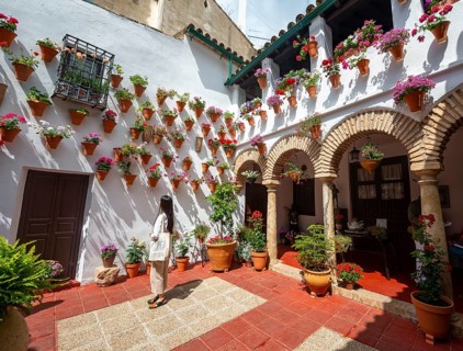 Young woman standing in a courtyard decorated with flowers