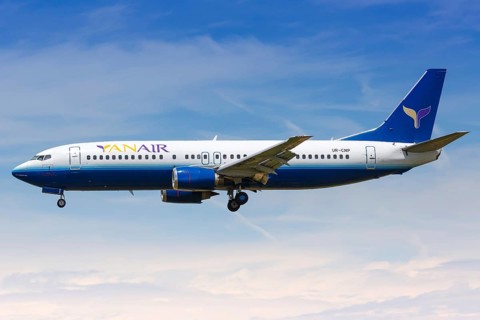 A YanAir Boeing 737-400 with the registration UR-CNP lands at Barcelona Airport