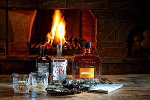 Various spirits with pipe in front of a burning fireplace with fire