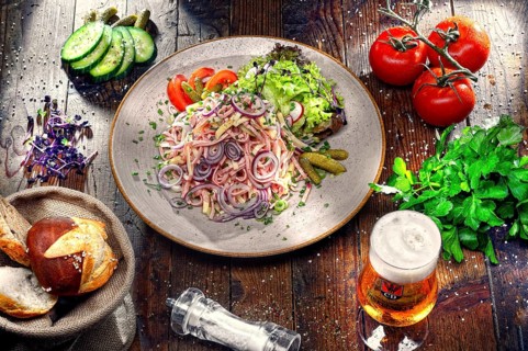 Swiss sausage salad with cheese and onion rings