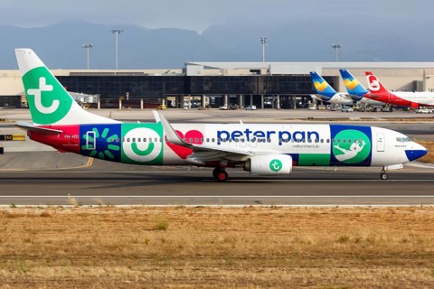 A Transavia Boeing B737-800 with the registration PH-HSI and the special livery Peter Pan Vakantieclub takes off from Palma de Majorca Airport