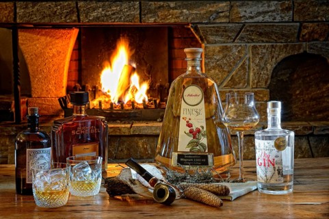 Various spirits with pipe in front of a burning fireplace with fire