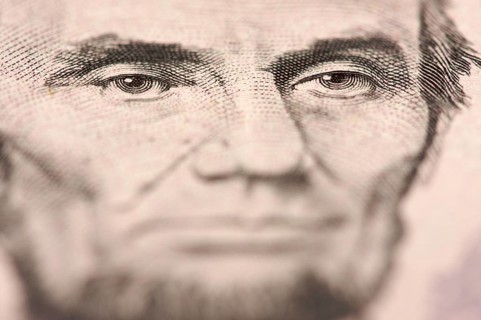 Abstract macro of U.S. five dollar bill's abraham lincoln face with narrow depth of field